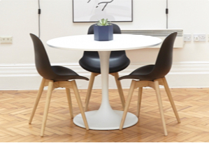 Small circular white table with black chairs